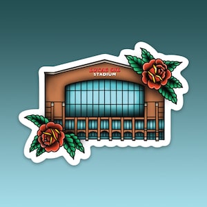 May include: A sticker featuring a stylized illustration of Lucas Oil Stadium in Indianapolis, Indiana. The stadium is depicted in brown and blue with the text "LUCAS OIL STADIUM" in red. Two traditional red roses with green leaves frame the stadium.