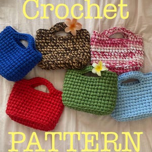 May include: A collection of handmade crochet bags in various colors, including blue, red, green, and pink. The bags have a square shape with a handle and are arranged on a white surface. The word "Crochet" and "PATTERN" are written in yellow.