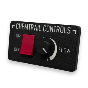 Puede incluir: Un panel de plástico negro con el texto "CHEMTRAIL CONTROLS" en letras blancas. El panel tiene un interruptor de palanca rojo etiquetado como "ON" y "OFF" y una perilla negra con un dial blanco etiquetado como "FLOW".