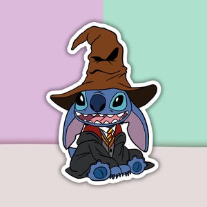 May include: A blue Stitch character wearing a brown wizard hat and a red and gold robe. The character is smiling and has a mischievous look on its face.