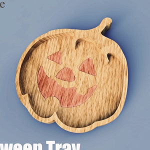 May include: A wooden Halloween tray in the shape of a jack-o'-lantern with a carved face. The tray is made of light-colored wood with a reddish-orange face. The text "Halloween Tray" is at the bottom.