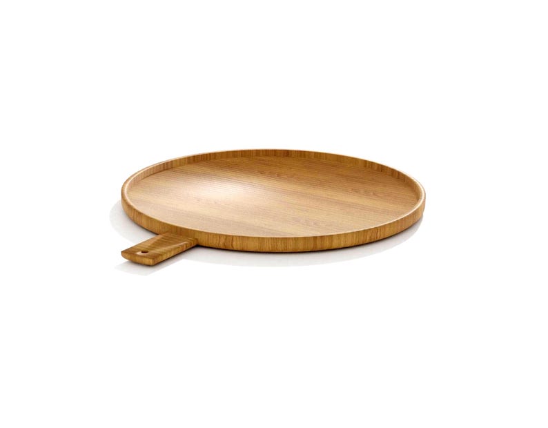 May include: A round, wooden serving tray with a handle. The tray is made of light brown wood and has a smooth surface. The handle is rectangular and attached to the side of the tray. The tray is designed for serving food or displaying items.