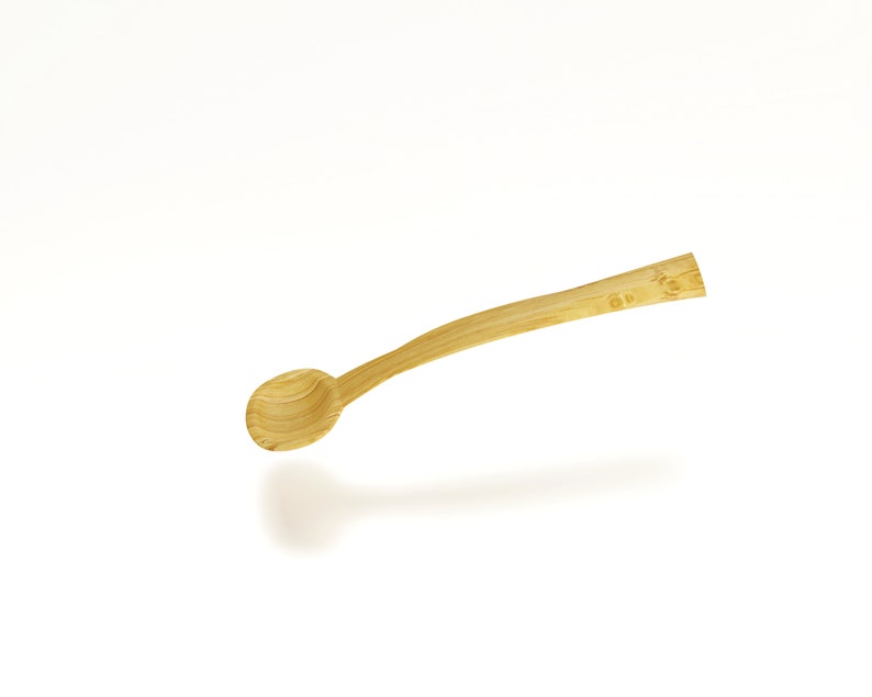 May include: A wooden spoon with a rounded bowl and a long, slender handle. The spoon is made of light brown wood and has a natural finish.