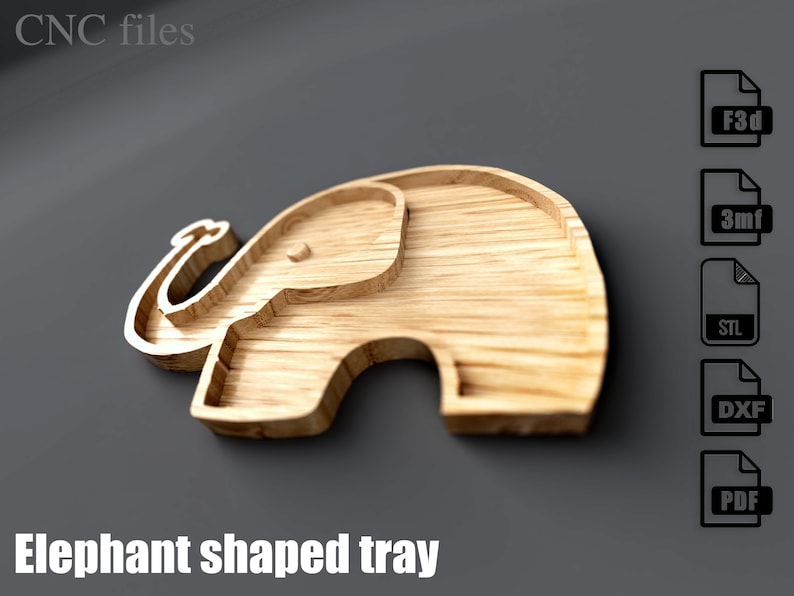 May include: A wooden elephant-shaped tray with a carved design. The tray is made of light-colored wood and features a detailed outline of an elephant. The text "Elephant shaped tray" is at the bottom. The image also includes file type icons.