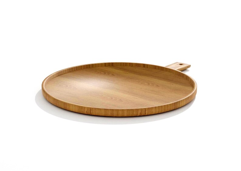 May include: A round, light brown wooden serving tray with a handle. The tray has a raised edge and a smooth surface, ideal for serving food or displaying items. The handle has a hole for hanging.