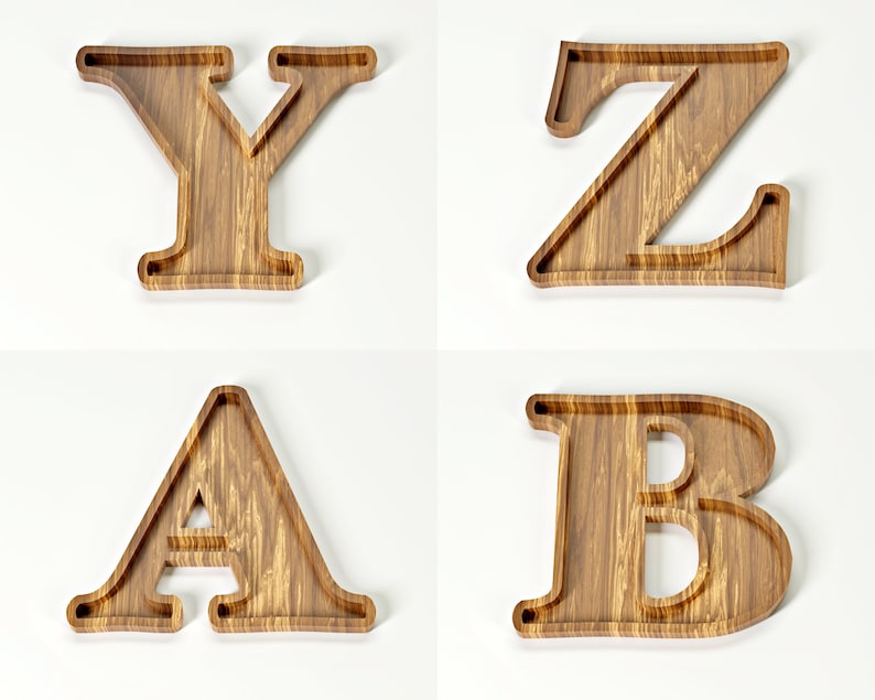 May include: Four wooden letters: Y, Z, A, and B. Each letter is carved from light brown wood with a visible grain pattern. The letters have a tray-like design, with a recessed area within the outline of each letter. The background is plain white.