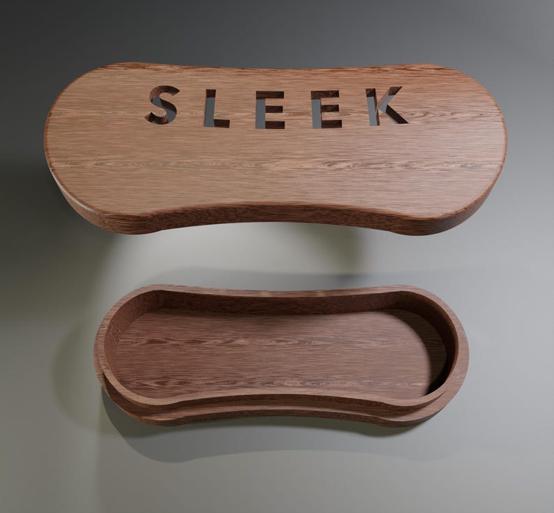 May include: Two-piece wooden storage box with a natural wood grain finish. The top piece has the word "SLEEK" cut out. The bottom piece is a tray with curved edges. The pieces are made of a warm brown wood.