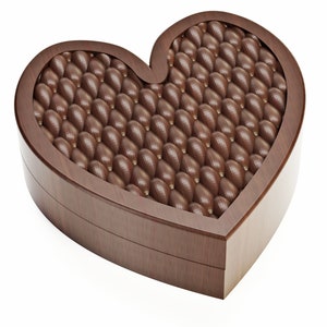 May include: A heart-shaped wooden box filled with numerous chocolate candies. The candies are oval-shaped and have a textured surface. The box is made of dark brown wood and is set against a white background. The chocolates are a rich brown color.