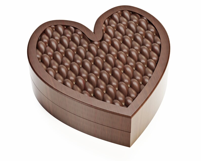 May include: A heart-shaped wooden box filled with numerous chocolate candies. The candies are oval-shaped and have a textured surface. The box is made of dark brown wood and is set against a white background. The chocolates are a rich brown color.
