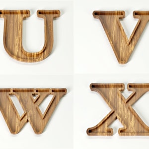 May include: Four wooden letter trays: U, V, W, and X. Each tray is crafted from light brown wood with a visible grain pattern. The letters are designed with a recessed interior, creating a tray-like shape, perfect for serving or display.