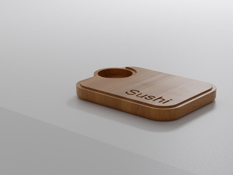 May include: A wooden sushi serving board with a recessed circular area and the word "Sushi" engraved on the surface. The board is rectangular with rounded corners and a raised edge, made of light brown wood.