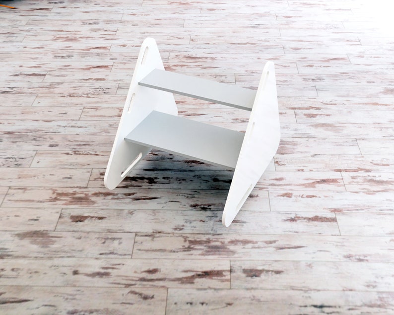 May include: A set of three ceramic mugs with a speckled, matte finish. The mugs are in shades of cream, light grey, and dark grey. Each mug has a simple, minimalist design, ideal for coffee or tea.