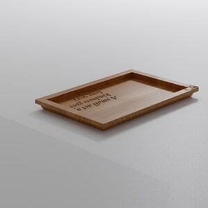 May include: A rectangular wooden tray with a raised border. The tray is light brown and features the engraved text "A small act of kindness goes a long way."
