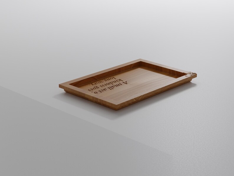 May include: A rectangular wooden tray with a raised border. The tray is light brown and features the engraved text "A small act of kindness goes a long way."