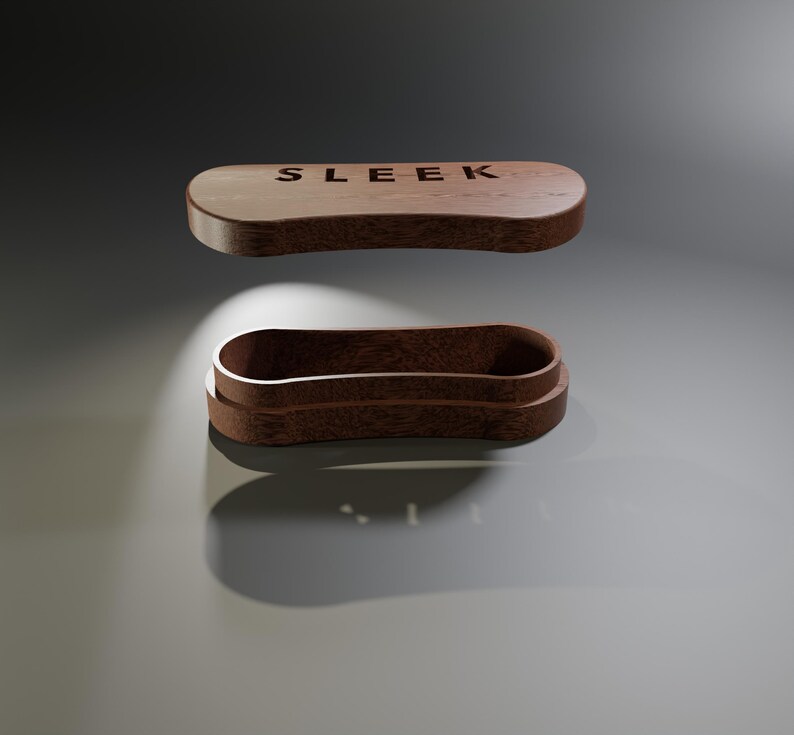 May include: A wooden, oval-shaped box with the word "SLEEK" engraved on the lid. The box is open, revealing the interior. The wood has a warm, brown tone, and the design is minimalist and modern.
