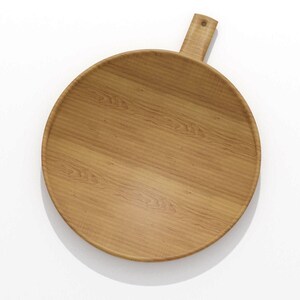 May include: A round wooden serving board with a handle. The board is made of light brown wood and has a natural wood grain pattern. The handle is rectangular and has a hole for hanging. The board is approximately 12 inches in diameter.