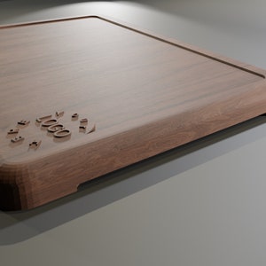 May include: A large, rectangular wooden cutting board with a rounded edge and a raised logo that reads "TOOGO" in a circular design.