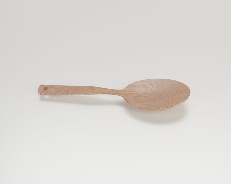 May include: A light-colored wooden spoon with a large, rounded bowl and a long handle. The spoon has a small hole at the end of the handle. The wood grain is visible. This kitchen utensil is designed for stirring and serving.