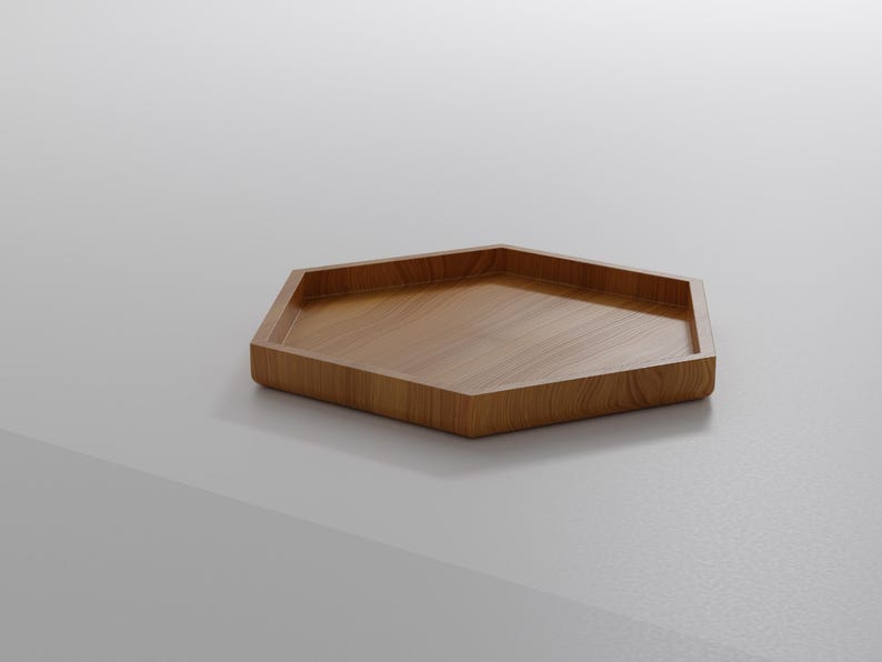 May include: A hexagonal wooden tray with a light brown finish. The tray has a shallow, recessed interior and a smooth, polished surface. The tray is made of wood and is suitable for serving or displaying items.