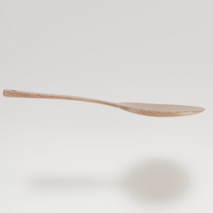 May include: A light-colored wooden spoon with a long, curved handle and a wide, oval bowl. The spoon is made of a light-colored wood, possibly maple or birch, and has a smooth, natural finish. The spoon is designed for cooking and serving.