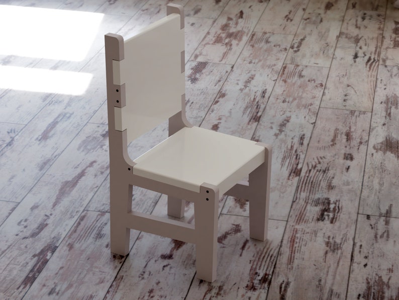 May include: A small, light-colored wooden chair with a white seat and back. The chair has a simple, modern design with a rectangular seat and backrest. The frame is a light gray color, and the chair is set on a wooden floor.