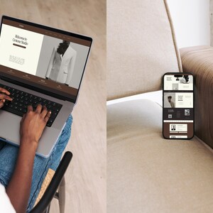 May include: A person is using a laptop computer with a website open that says "Welcome to Grace Studio". The website has a picture of a white blazer. A smartphone is on a brown couch with a website open on the screen.