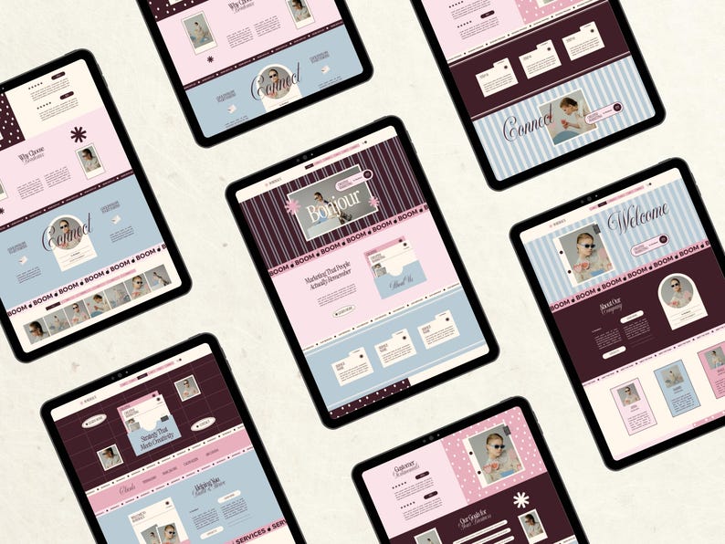 May include: Seven tablets arranged in a circular pattern, each displaying a unique website interface design. The screens feature a color palette of soft pink, light blue, and dark maroon, incorporating text elements like Bonjour, Connect, and Welcome.