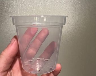 May include: A clear plastic plant pot with drainage holes at the bottom.