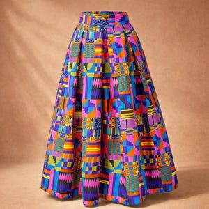 May include: A vibrant, full-length skirt with a bold geometric pattern. The skirt features a high waist and a flowing A-line silhouette. The design incorporates blocks of color in shades of purple, blue, orange, pink, and yellow.