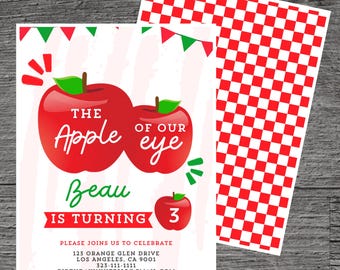 Puede incluir: Una invitación de cumpleaños de temática de manzana roja y verde para un niño que cumple tres años. La invitación presenta dos manzanas rojas con el texto "The Apple of Our Eye" y el nombre del niño "Beau" con el texto "Is Turning 3". La invitación también incluye la dirección, el número de teléfono y la dirección de correo electrónico para el evento.
