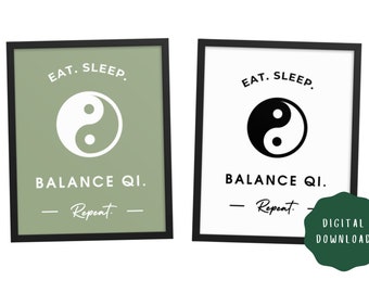 May include: Two framed prints with black borders. One has a sage green background with a white Yin Yang symbol and text that reads "EAT. SLEEP. BALANCE QI. Repeat." The other has a white background with a black Yin Yang symbol and the same text.