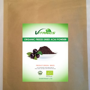 May include: A brown paper bag with a green and white label featuring the text "VITANICS ORGANIC FREEZE DRIED ACAI POWDER." The label also shows a pile of dark powder, acai berries, and leaves. The product origin is Brazil.