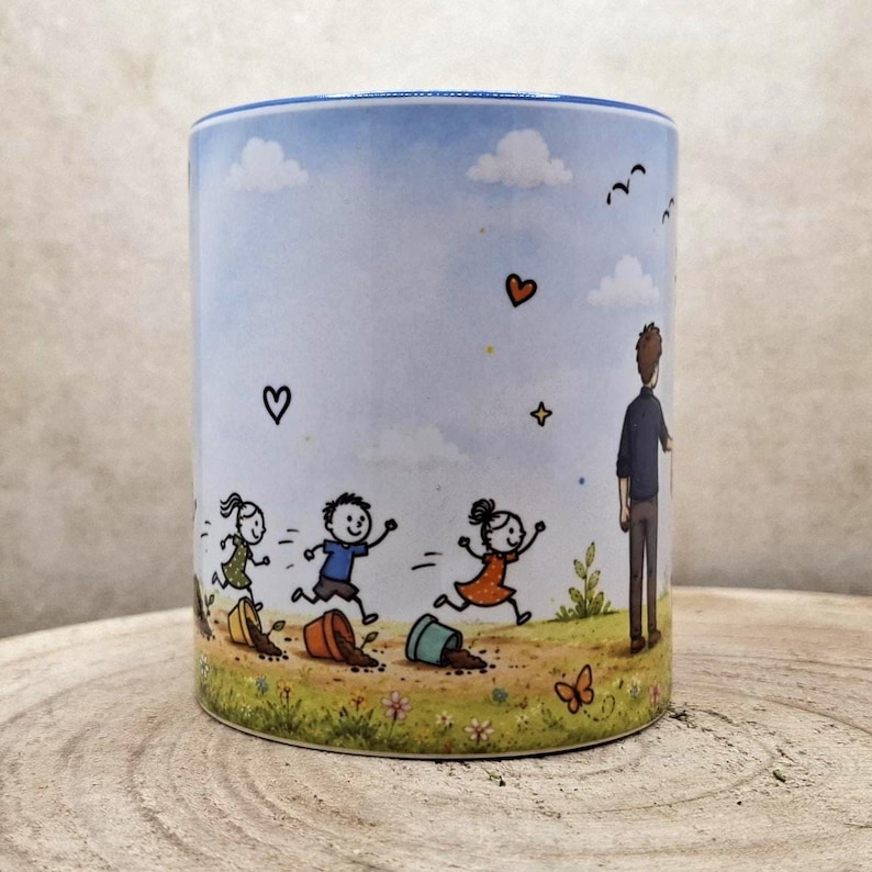 May include: A ceramic mug with a whimsical illustration of children running and playing. The design features a blue sky with clouds, hearts, and a figure of an adult watching the children. The mug has a blue rim and a light-colored background.
