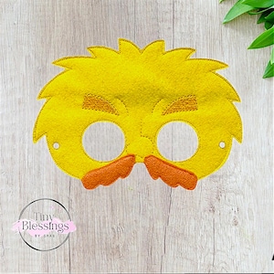 May include: Yellow felt mask with a fuzzy texture, featuring a pair of black eye holes, a brown mustache, and two brown eyebrows.