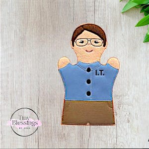 May include: Blue felt puppet with a brown felt skirt and glasses. The puppet has a name tag that says "I.T."