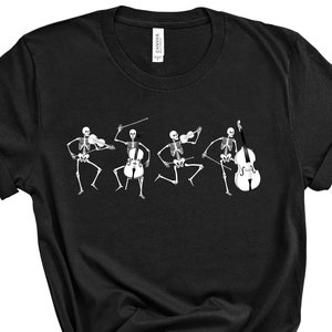 May include: Black t-shirt with a graphic of skeletons playing musical instruments. The skeletons are playing a cello, violin, and a double bass.