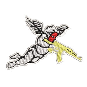 May include: White embroidered patch of a winged cherub wearing a red mask and holding a yellow rifle.