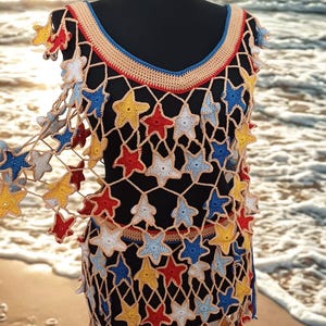 evil eye crochet dress Style it as a dress or pair it with the Evil Eye Hand-Crochet Topeither  way, you'll turn all eyes on you! #skirt #dress #top #resortwear  #handcrochet #emilyinparis