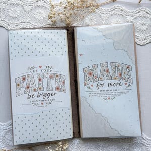 May include: A notebook with two inserts featuring floral-patterned text. The left insert reads LET YOUR FAITH be bigger THAN YOUR FEAR JOSHUA 1:9. The right insert reads MADE for more EPHESIANS 2:10 with additional text below the verse.
