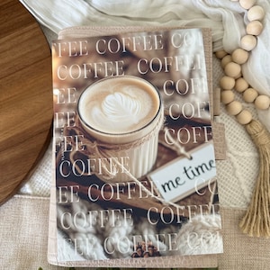 May include: A pink leather planner with a coffee cup and the words "FEE COFFEE CO" and "me time" printed on it.