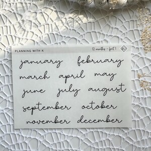 May include: A sheet of white paper with the months of the year written in black cursive script. The text reads "Planning with K 12 months - font 1".