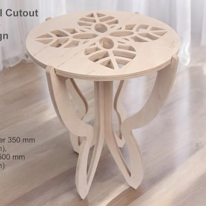 May include: A light wood table with a floral cutout design. The table is 13.8 inches in diameter and 19.7 inches tall.