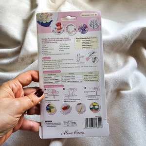 May include: A punch needle set with a variety of needles for different thread thicknesses. The set includes a long needle threader, a fine needle, a medium needle, and a large needle. The packaging also includes instructions on how to use the needles and a description of the different stitches that can be created.