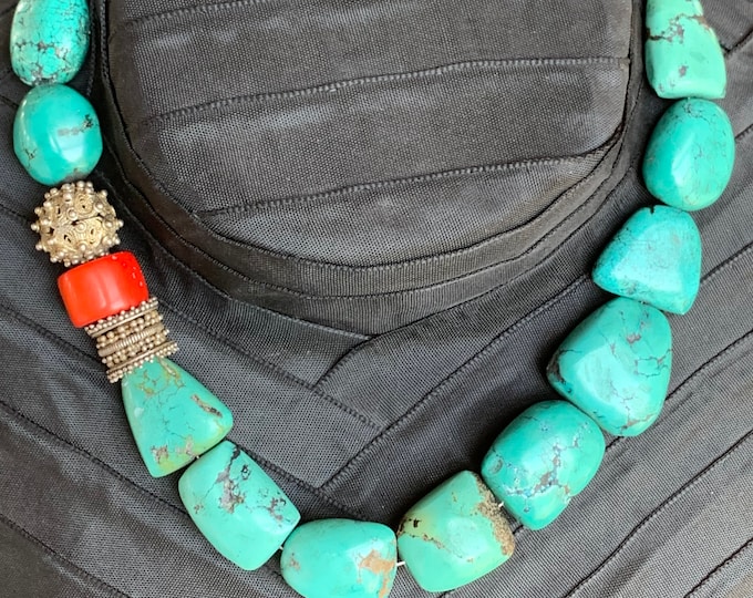Turquoise necklace with antique silver parts and coral.