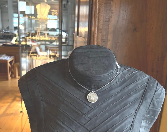 Indian rupee coin on silver chain