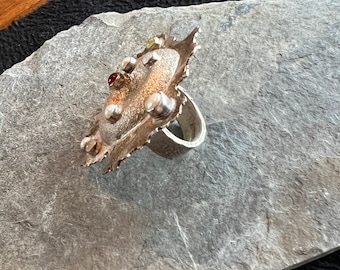 silver ring with pearls and gemstones