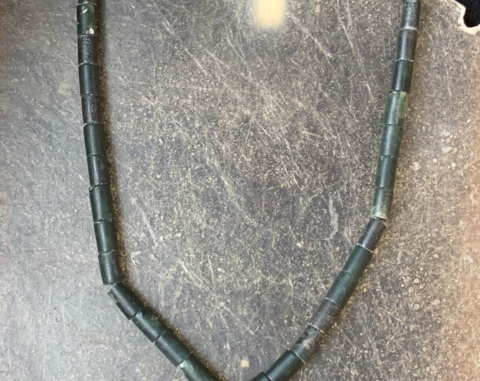 Jade necklace threaded on a cord with silver clasp