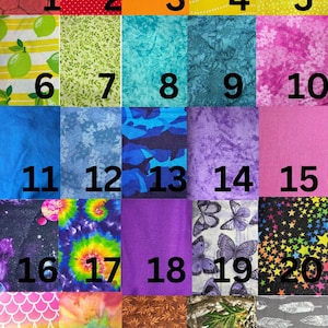 May include: A fabric swatch chart with 29 numbered fabric samples. The fabrics include various colours and patterns, such as red, orange, blue, purple, and green. The word "FABRICS" is at the top.