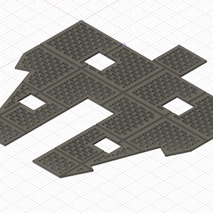 Puede incluir: Un modelo 3D impreso en gris de una forma geométrica compleja con múltiples paneles rectangulares y recortes. El modelo tiene una superficie texturizada y parece estar diseñado para un propósito específico.