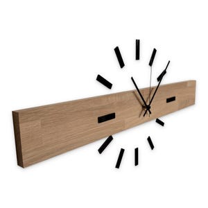 May include: A contemporary wall clock with a light brown wooden base and black rectangular details. The clock hands and hour markers are black, offering a minimalist aesthetic. The clock is approximately 76 cm in length.